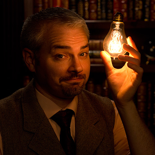 magician peter wood holding a lightbulb