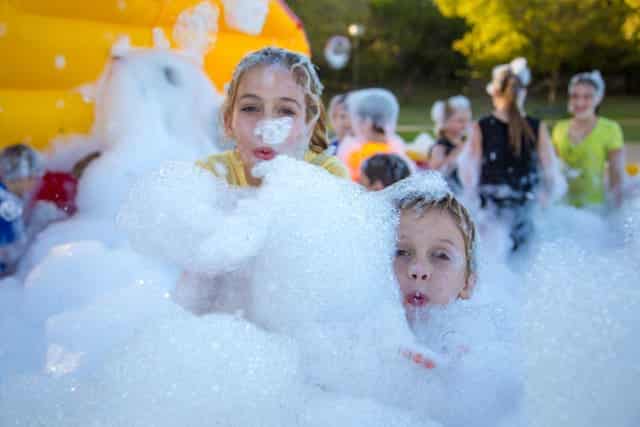 Children covered in bubbles