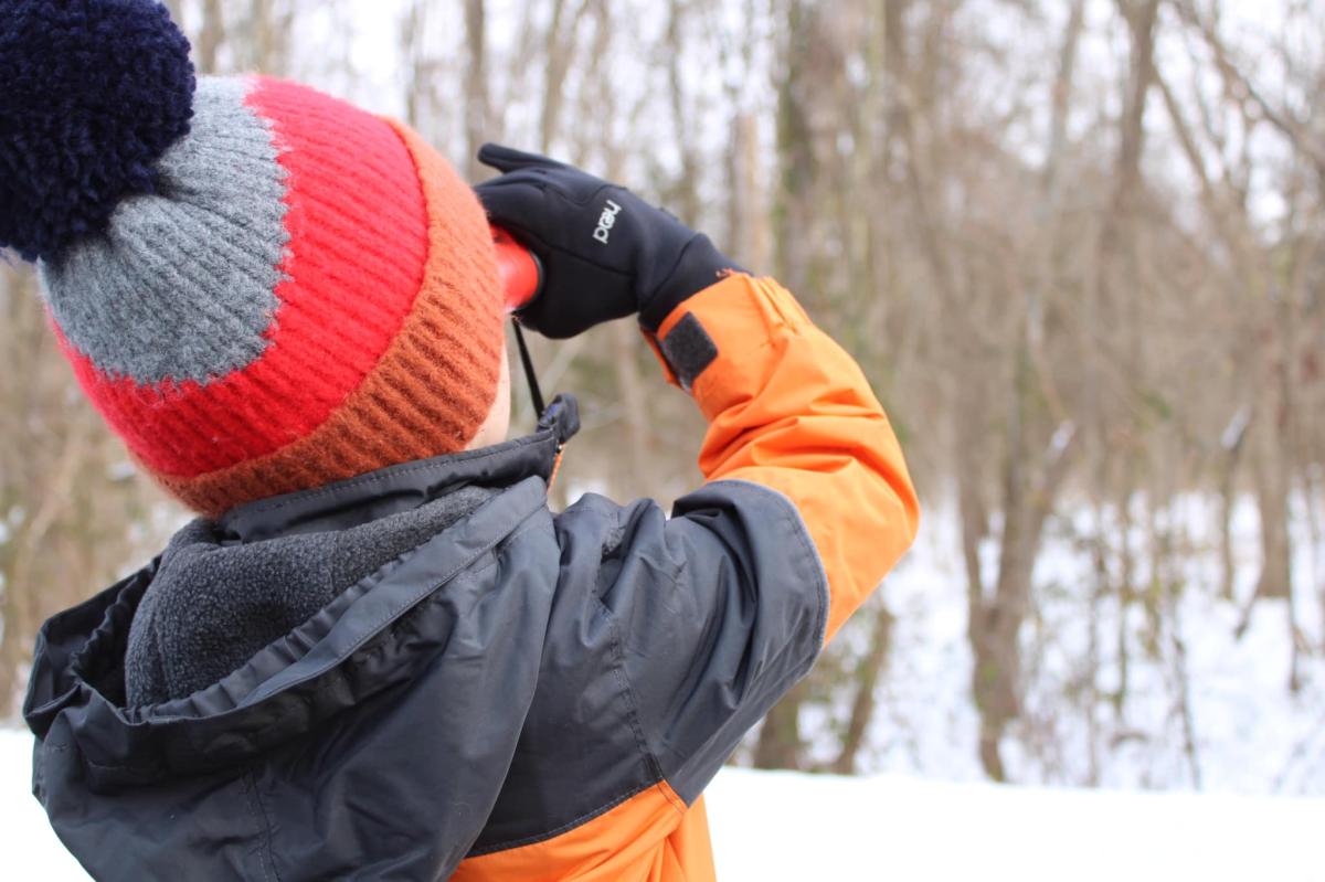 a child looking through binoculars