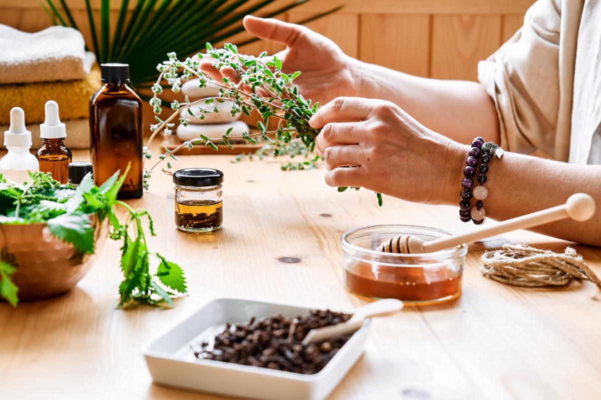 Wood table with a persons hands planting seeds in bowls